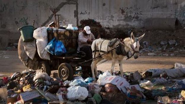 Un employé palestinien collecte des ordures avec sa charrette tirée par un âne, le 26 novembre 2013 à Gaza Un employé palestinien collecte des ordures avec sa charrette tirée par un âne, le 26 novembre 2013 à Gaza