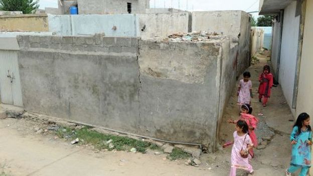 Des jeunes filles passent à proximité de la maison de Rimsha